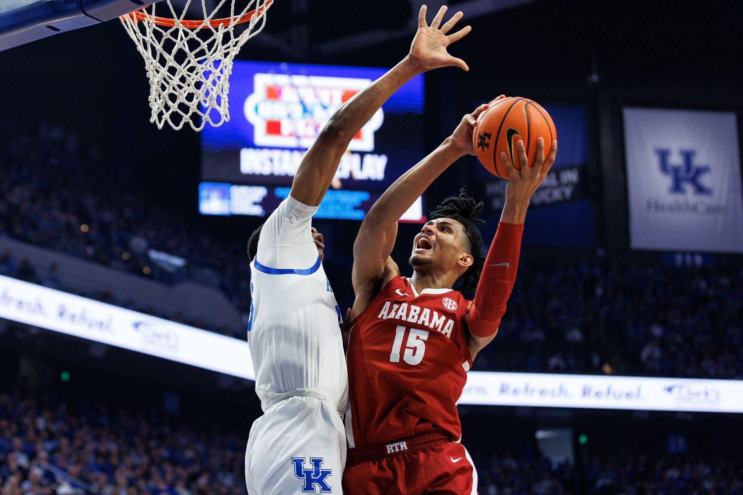 Feb 24, 2024; Lexington, Kentucky, USA; Alabama Crimson Tide forward Jarin Stevenson (15) goes to the basket against Kentucky Wildcats forward Ugonna Onyenso (33) during the first half at Rupp Arena at Central Bank Center. Mandatory Credit: Jordan Prather-USA TODAY Sports